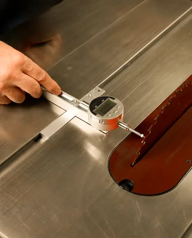 A dial indicator setup in a table saw measuring blade plate runout